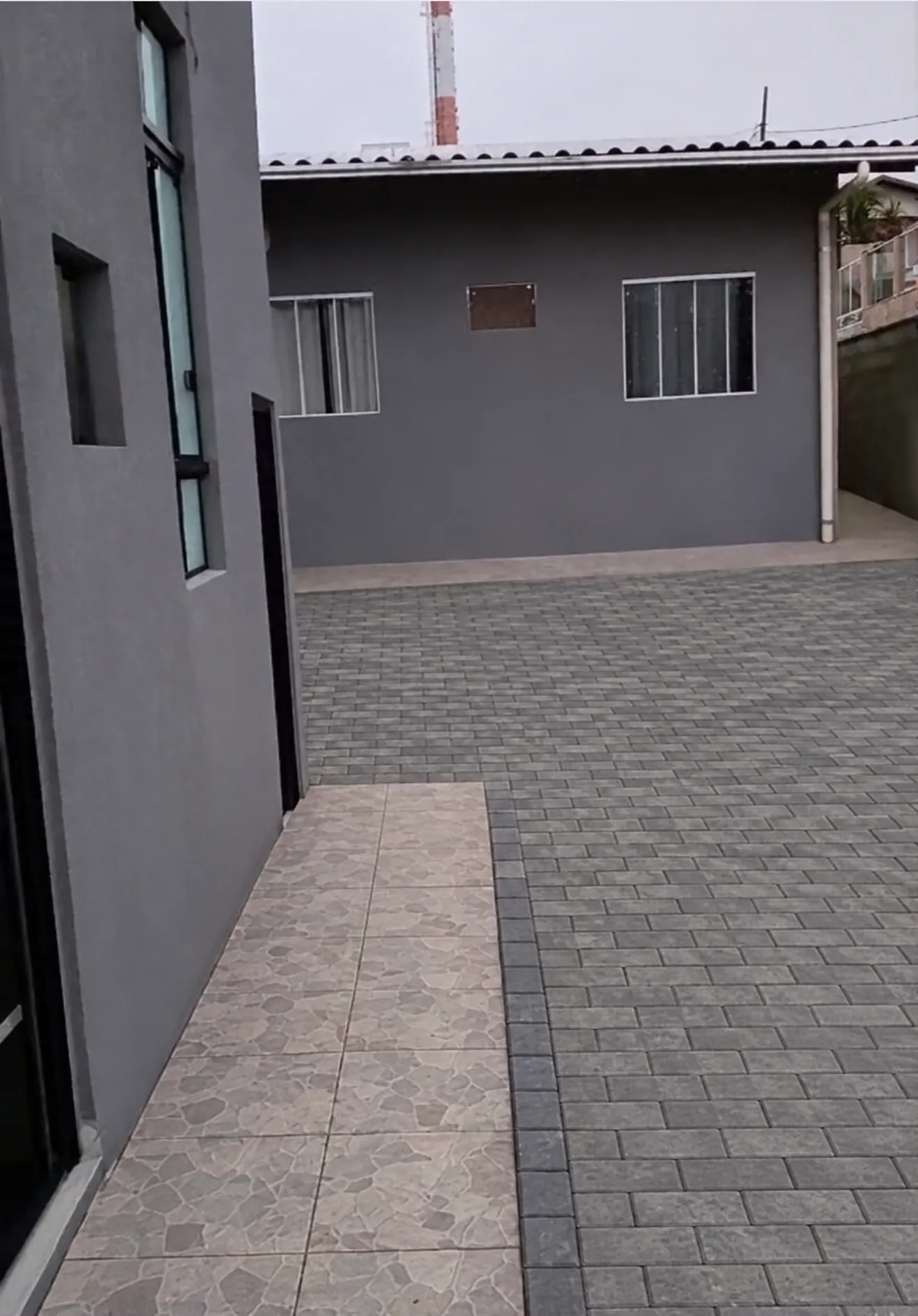 The detached two-bedroom house (courtyard paving shown finished)
